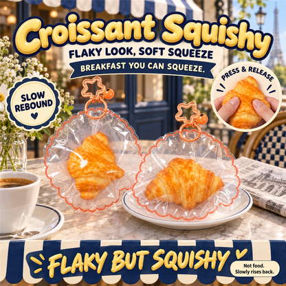 Croissant Squishy poster - golden croissant squishies in clear frilly pouches on a Paris cafe table with an espresso
